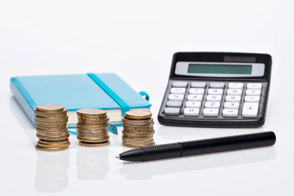 Munt stapel, zakrekenmachine en notebook — Stockfoto