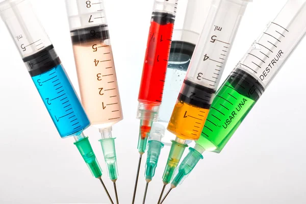 Various syringes filled with colored liquids — Stock Photo, Image