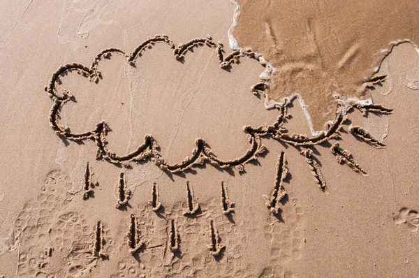sun and cloud drawing on beach sand