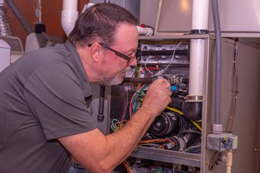 HVAC Tech Fixing A Gas Furnace  Gray Shirt  clipart