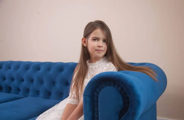 Beautiful Girl Sits Blue Sofa Looks Sad — 图库照片