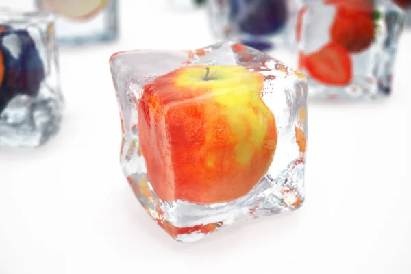 苹果在冰立方体被隔绝在白色与深度的场效应 有新鲜浆果的冰块 浆果冻在冰块里 — 图库照片