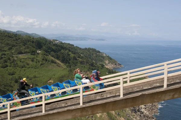 Holidaymakers riding on a roller coaster ride in Northern Spain — Stock Photo, Image