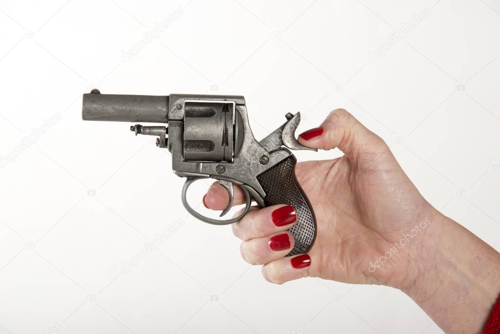 Woman's hand holding a hand gun