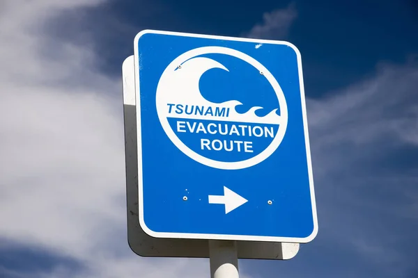 Tsunami flood evacuation route road sign Stock Picture