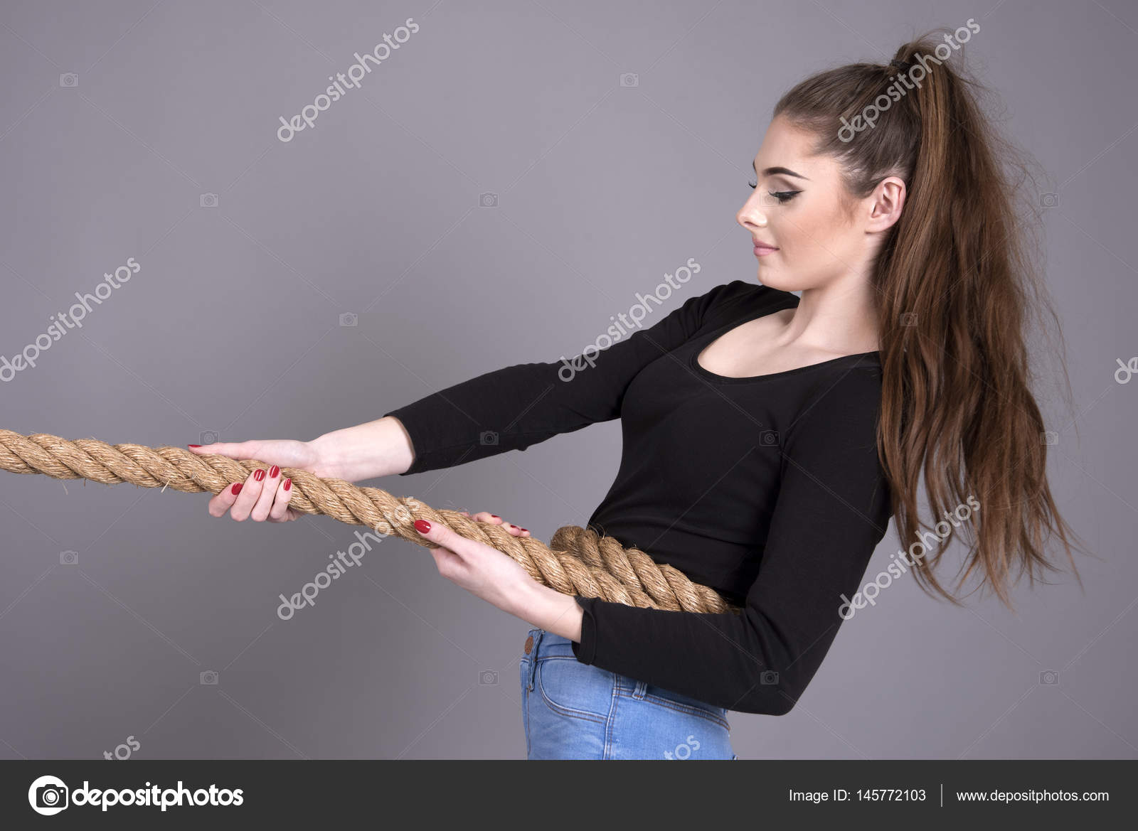 Tug of war concept with girl pulling a rope — Stock Photo © petertt  #145772103