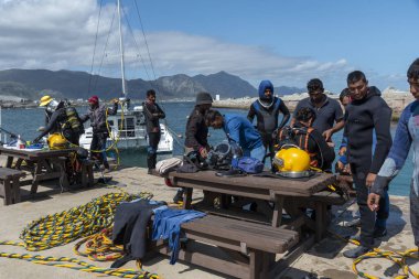 Hermanus, Batı Burnu, Güney Afrika. Aralık 2019. Profesyonel dalgıçlar eğitim kursu, Hermanus 'taki New Harbour' da çalışan öğrenciler..