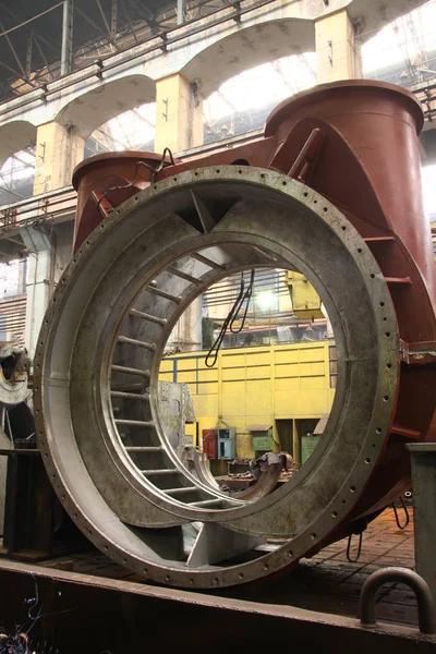 Industrial production of turbines for heavy industry. Huge steel turbine components. Industrial. Manufacture of water turbines. The huge machine turbine production. Large parts of the plant.