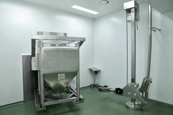 Container mixer at the factory of pharmacy. Production of tablets. A container for mixing suspensions for tablets. Automatic device for the release of a drug mixture. Innovative production of quality