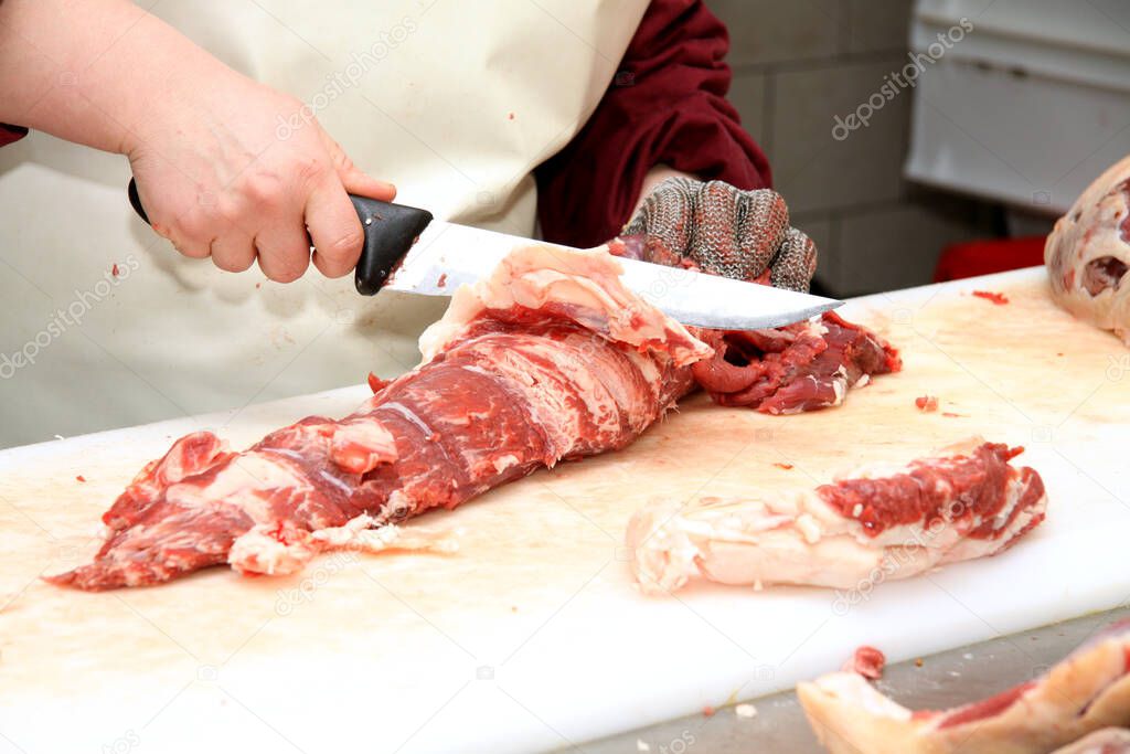 Prepares sausages at the work table. Food processing and processing industry. Raw meat mix: steaks, poultry, sausages, ham, chopped, minced meat. The farm. Unique home production.