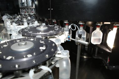 İlaç endüstrisi, ilaç hapları ilaç fabrikasındaki üretim hattı makinesinin plastik şişesini dolduruyor. Ampul doldurma ve mühürleme makinesi, ilaç ekipmanları.
