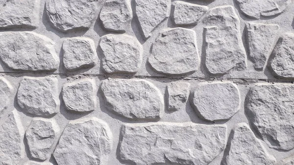 The texture of the stone wall. Old castle stone wall texture background. Stone wall as a background or texture. Part of a stone wall, for background or texture