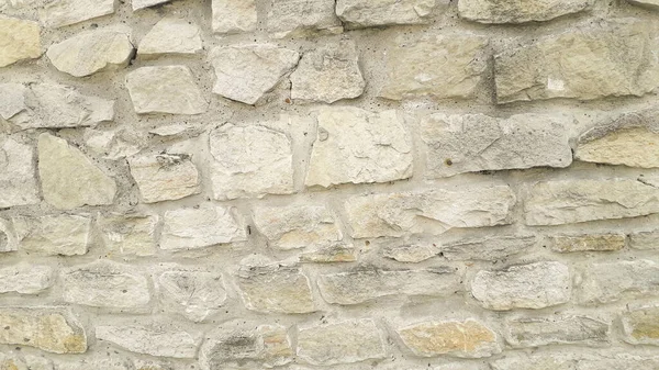 The texture of the stone wall. Old castle stone wall texture background. Stone wall as a background or texture. Part of a stone wall, for background or texture