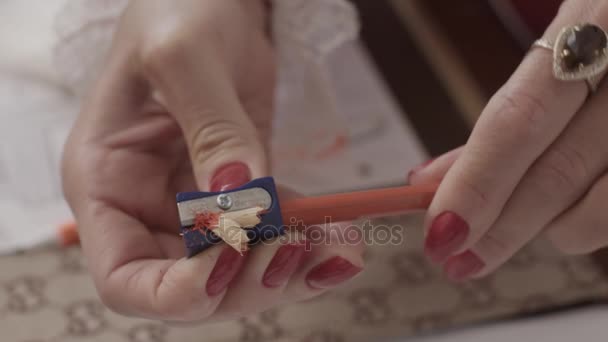 Woman sharpens a pencil — Stock Video