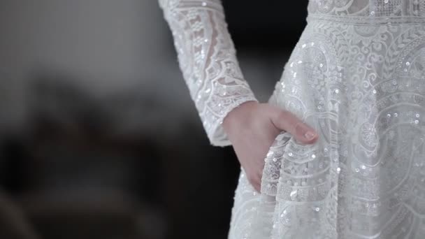 Young woman in long wedding dress with glittering decoration — Stock Video