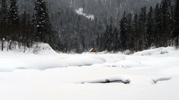 Una Casa Orilla Del Río Las Montañas Durante Una Nevada — Vídeos de Stock