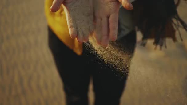 Close up of woman pouring sand running through fingers slow motion at the desert on sunset, slow motion. — Stock Video