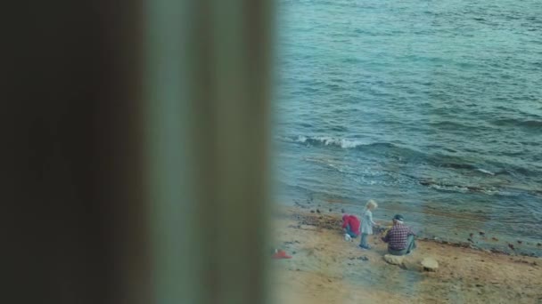 Avô com netos brincando na praia junto ao mar, câmera lenta, 4k — Vídeo de Stock