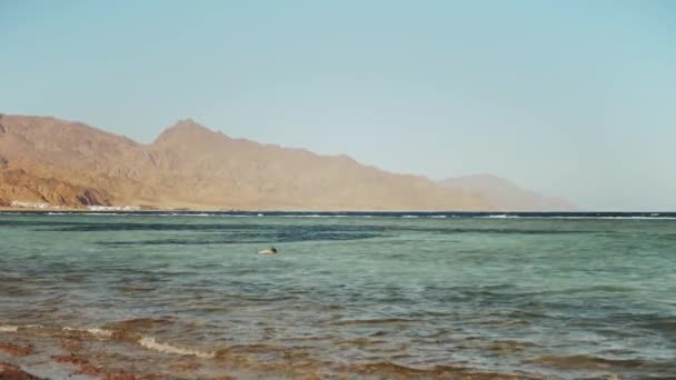 Krásná krajina modrého moře a jasná obloha, vlny v moři a hory na obzoru Egypt, Dahab, zpomalení, 4k — Stock video