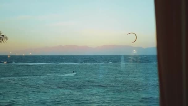 Kite surf dans une belle eau claire à Dahab Egypte. Explorer l'eau bleue avec les montagnes en arrière-plan et les gens planche à voile et kite surf, ralenti, 4k — Video