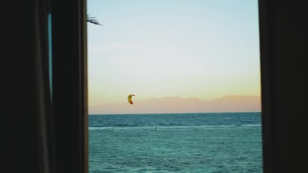 Pessoas Kite surf na bela água limpa em Dahab Egito ponto de vista da janela. Explorando o mar azul com montanhas no fundo e as pessoas kite surf, câmera lenta, 4k — Vídeo de Stock