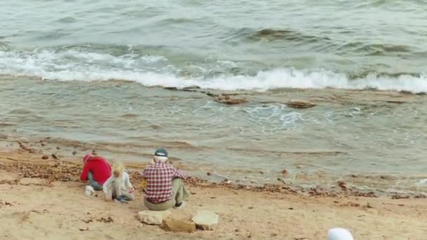 Grandfather with grandchildren playing on the beach by the sea, slow motion, full hd — Stock Video