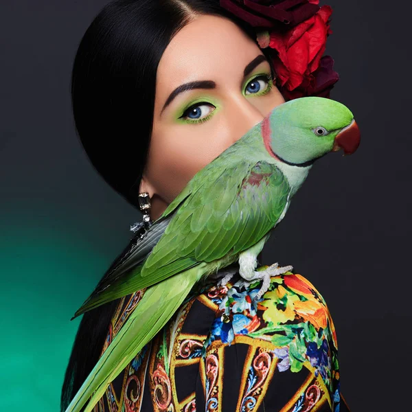 beautiful woman with a parrot and a flower