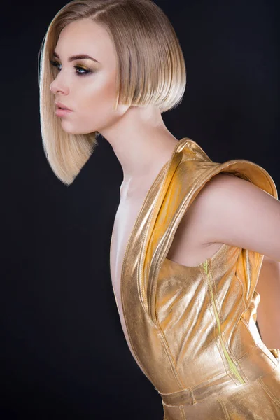 Futuristic sexy woman in golden dress — Stock Photo, Image