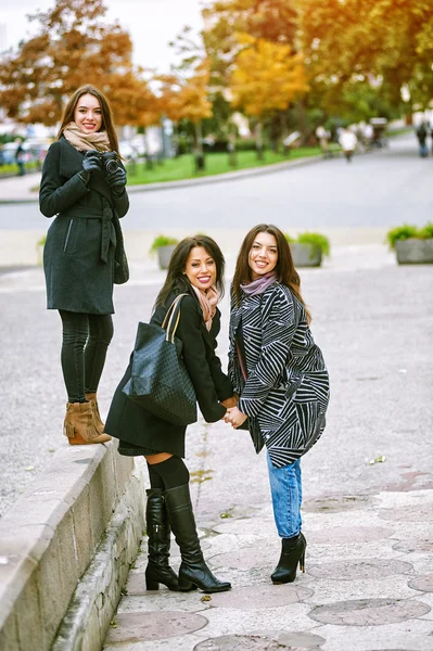 Tres chicas atractivas jóvenes que se divierten tomando fotos juntos en el paseo por la ciudad. Una forma de vida  . —  Fotos de Stock