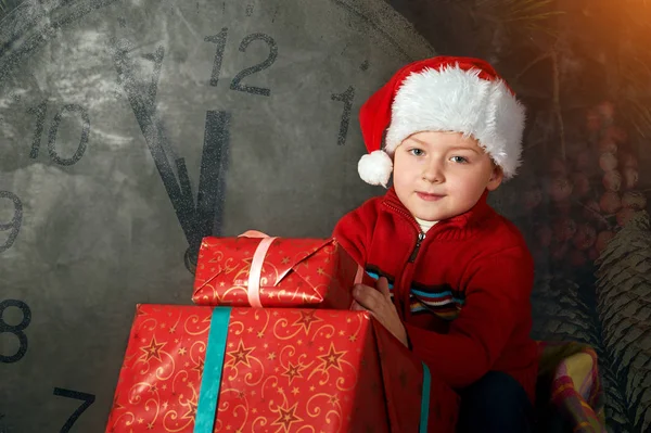 Menino assistente de Papai Noel em um fundo preto, com — Fotografia de Stock