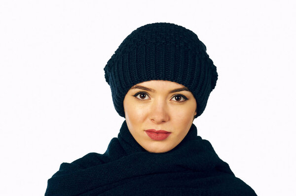 Portrait of girl in knitted hat and scarf , closeup on white background