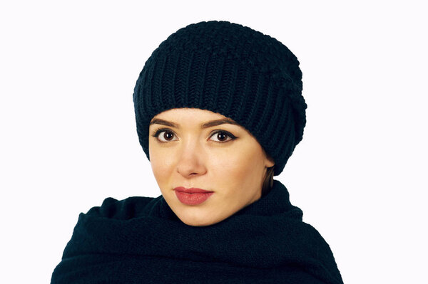 Portrait of girl in knitted hat and scarf , closeup on white background
