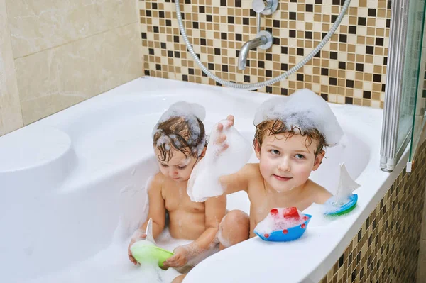 Cheerful children playing in the bathroom .Brother and sister enjoying water procedures — Stock Photo, Image