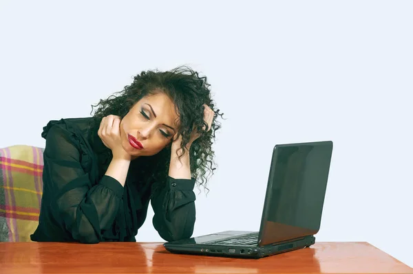 Tired woman sitting at the table after a hard day Royalty Free Stock Images