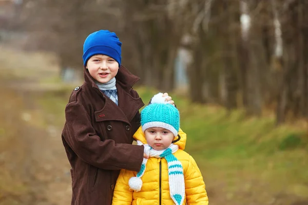 Children on a spring walk .Brother and sister having fun . — Stock Photo, Image