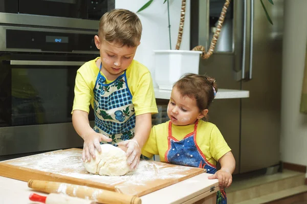 Дети помогают матери готовить обед. Домашняя еда и маленькие помощники — стоковое фото