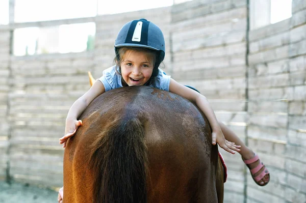 骑在马背上的小女孩。教孩子骑的概念 — 图库照片