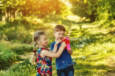 Gün batımında parkta sabun köpüğü ile çocuk oyun