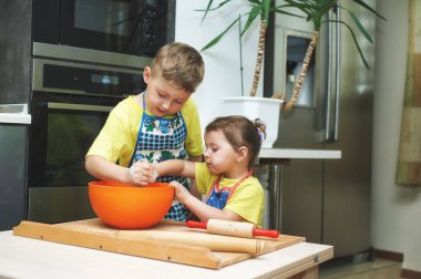 çocuklara anne yemek yemek yardım. Ev yapımı yiyecek ve küçük yardımcıları