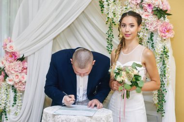 Düğün töreni. Gelin ve damat, kendi imzaları bırakarak