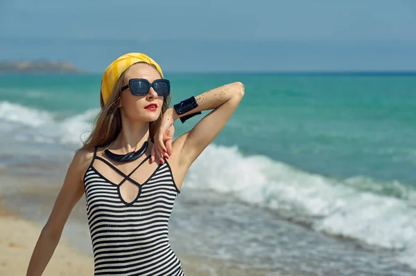 Ung kvinna på stranden vid kusten — Stockfoto
