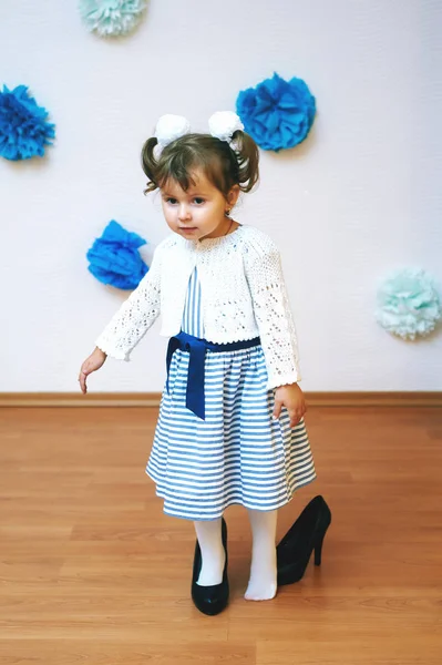 beautiful little girl in mom\'s shoes