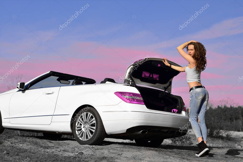 Beautiful sexy woman in a white cabriolet.