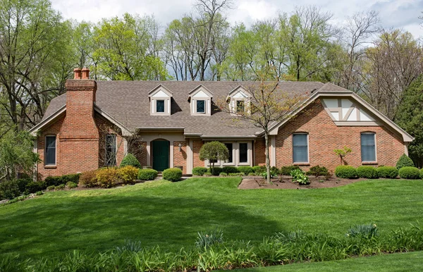 Grand Brick Home with Landscaped Lawn