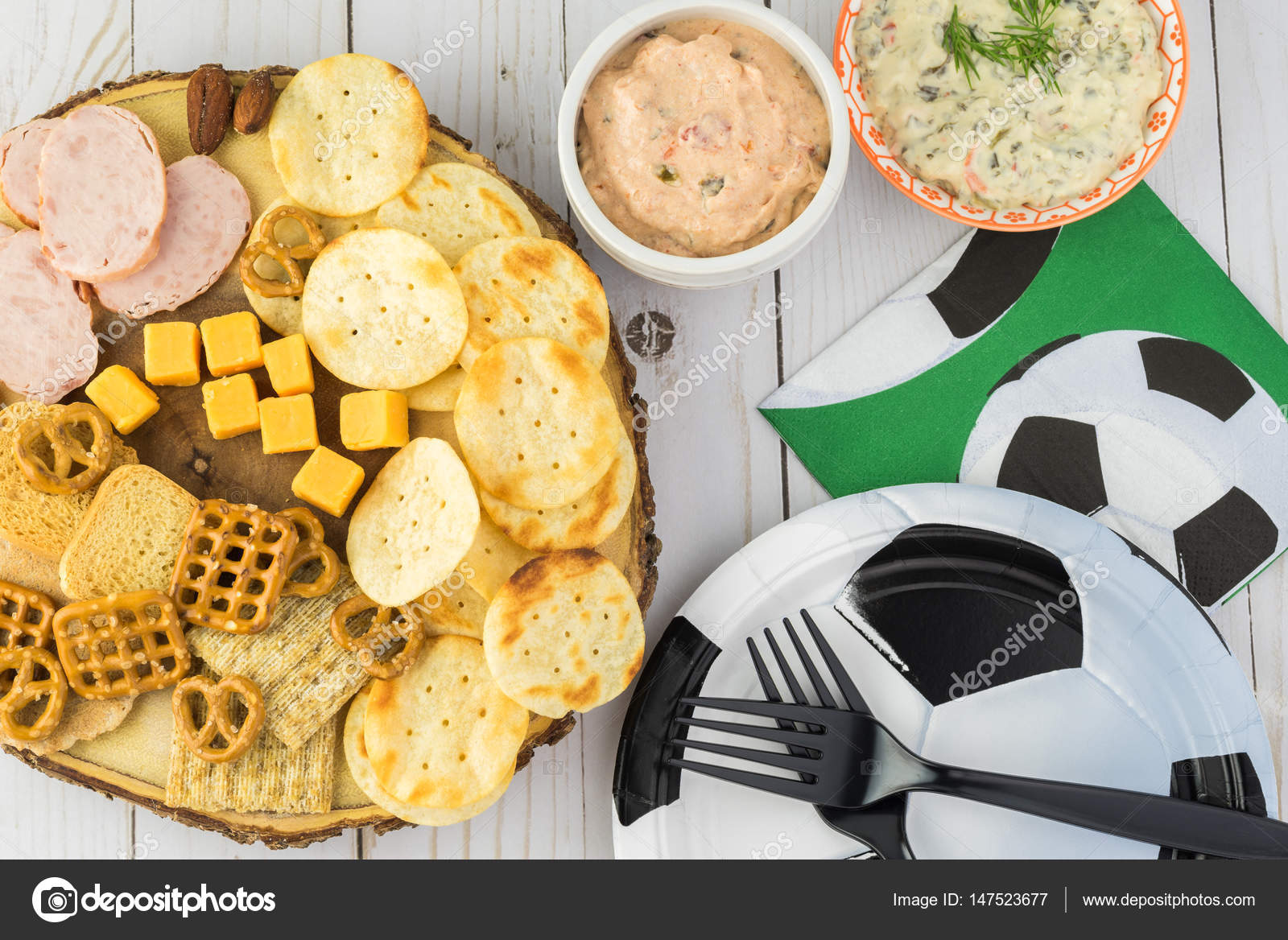 party table for soccer game with variety of snacks and dips stock