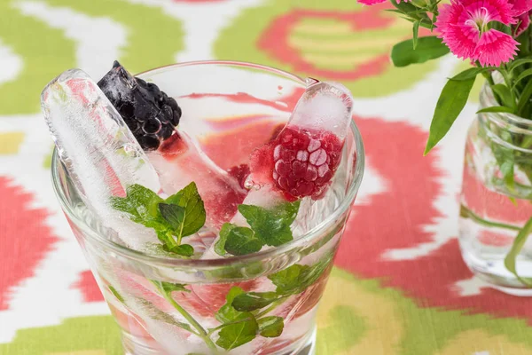 Ice cubes with fresh berries. — Stock Photo, Image