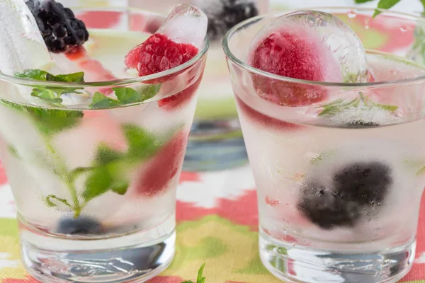 Ice cubes with fresh berries. — Stock Photo, Image