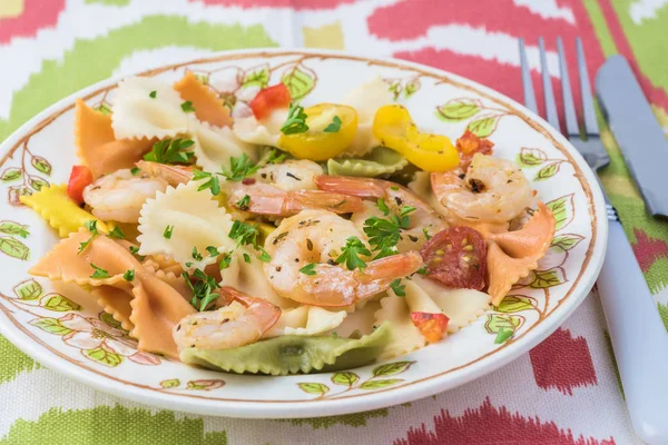 Shrimp veggie colorful bowtie pasta.