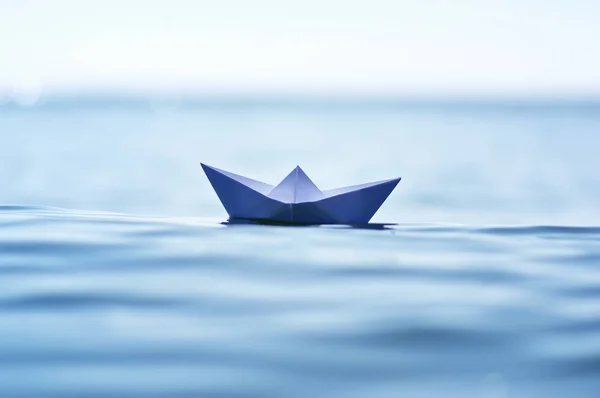 Paper boat on sea wave Stock Image