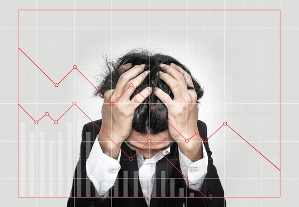 Stressed out businessman, with downward business graphs. Failure stock market and loss business investment profit concepts — Stock Photo, Image